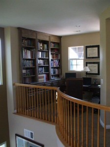 Built in desk and bookshelves in home office loft.